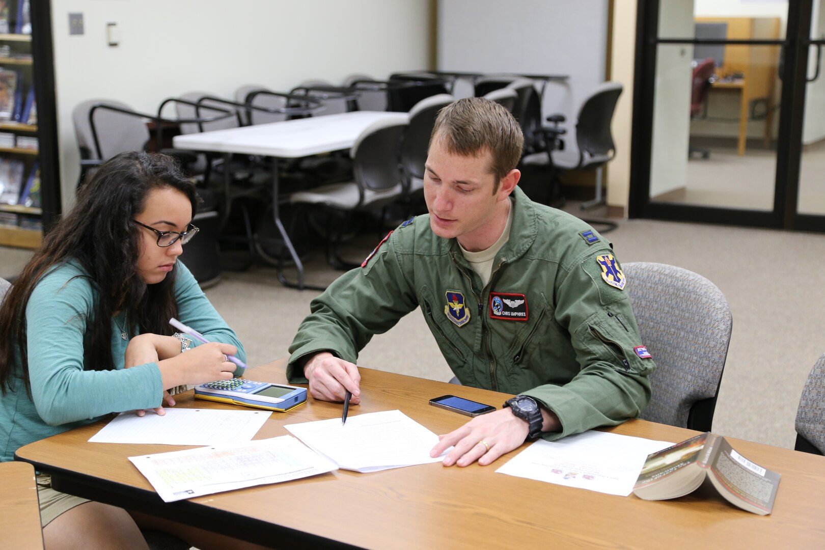 Elisabeth Gonzales (left), daughter of Chief Master Sgt. Terry Best-Rennahan, receives chemistry tutoring from Capt. Christopher Umphres, 435th Fighter Training Squadron instructor pilot, April 14 at the Joint Base San Antonio-Randolph library. Tutoring is offered 6-7 p.m. each Tuesday and Thursday at the library. For more information, call 652-5578 or 652-2617. (U.S. Air Force photo by Airman 1st Class Alexandria Slade)

