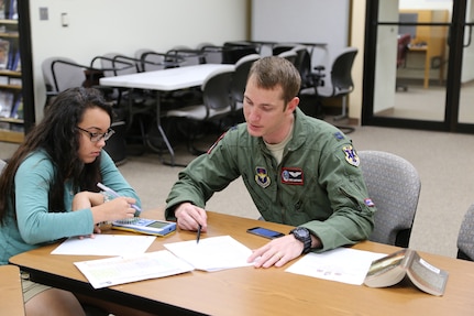 Elisabeth Gonzales (left), daughter of Chief Master Sgt. Terry Best-Rennahan, receives chemistry tutoring from Capt. Christopher Umphres, 435th Fighter Training Squadron instructor pilot, April 14 at the Joint Base San Antonio-Randolph library. Tutoring is offered 6-7 p.m. each Tuesday and Thursday at the library. For more information, call 652-5578 or 652-2617. (U.S. Air Force photo by Airman 1st Class Alexandria Slade)
