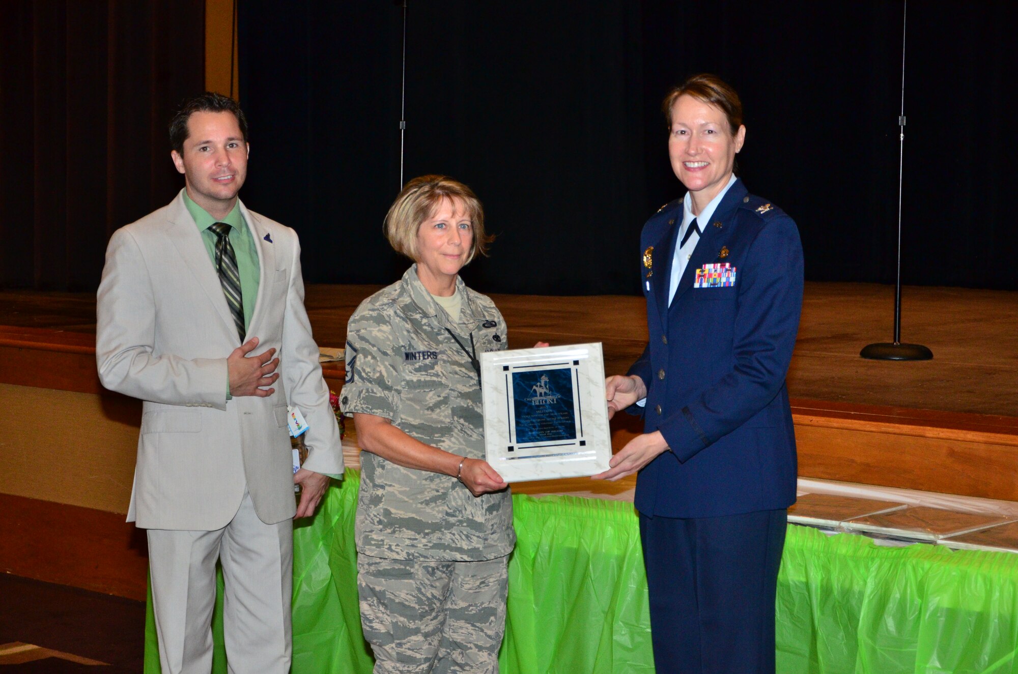 Master Sgt. Spring Winters, a unit training supervisor for the 403rd Maintenance Group, receives the military individual volunteer of the year award during the 32nd Annual City of Biloxi, Miss. Volunteer Recognition ceremony at the Biloxi Civic Center April 21 from City of Biloxi Mayor Robert Deming and Col. Susan Airola-Skully, the 81st Training Wing Mission Support Group commander.
