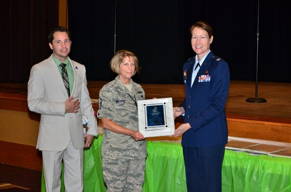 Master Sgt. Spring Winters, a unit training supervisor for the 403rd Maintenance Group, receives the military individual volunteer of the year award during the 32nd Annual City of Biloxi, Miss. Volunteer Recognition ceremony at the Biloxi Civic Center April 21 from City of Biloxi Mayor Robert Deming and Col. Susan Airola-Skully, the 81st Training Wing Mission Support Group commander. 