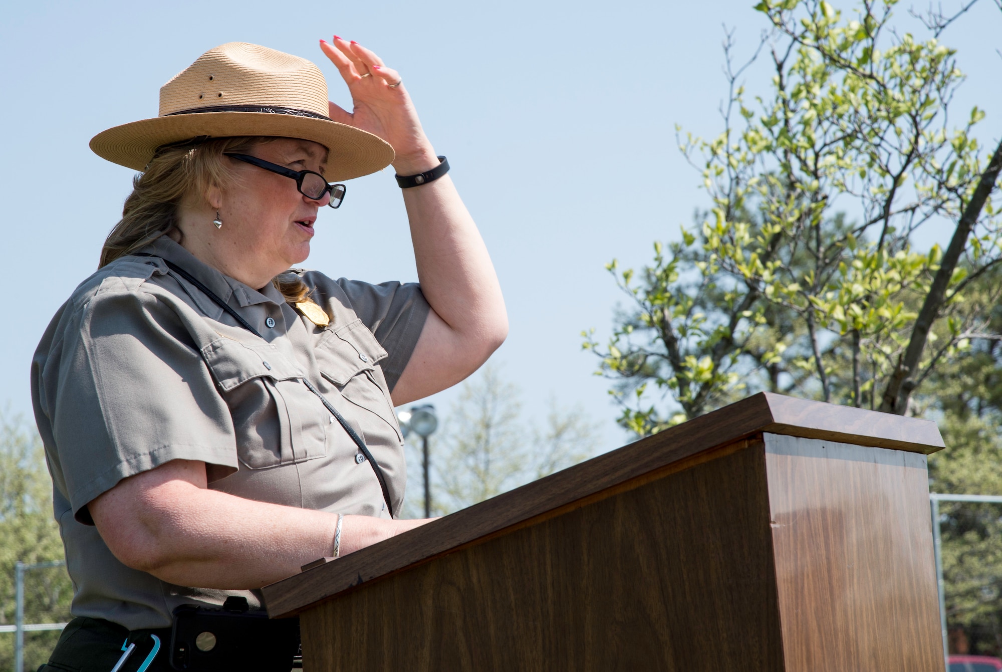 Julie Kutruff, National Capital Parks eastern district manager, speaks about the importance of protecting the environment during an Earth Day and Arbor Day ceremony outside Building 1657 at Joint Base Andrews, Md., April 22, 2015. Kutruff spoke about the importance of protecting the environment to approximately 40 people attending the ceremony. (U.S. Air Force photo/Airman 1st Class Philip Bryant)