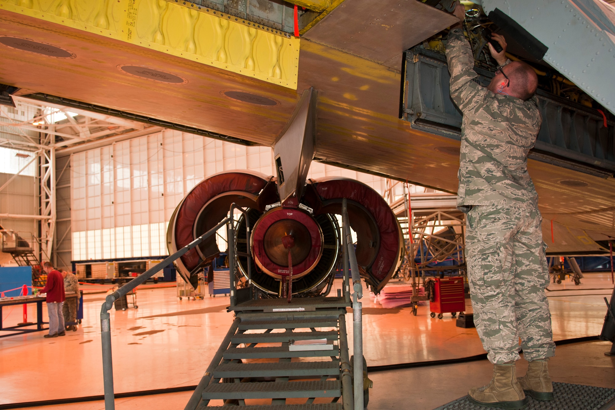 U.S. Air Force Master Sgt. Damon Drake, electrical and environmental specialist, 121st Air Refueling Wing, performs an inspection on a KC-135 Stratotanker during depot maintenance as part of Operation Team Spirit, Tinker Air Force Base, Okla., Mar. 2, 2015. The program teams unit maintenance Airmen up with depot facility personnel to perform inspections on aircraft as part of the depot maintenance process. (U.S. Air National Guard photo by Senior Airman Wendy Kuhn/Released)