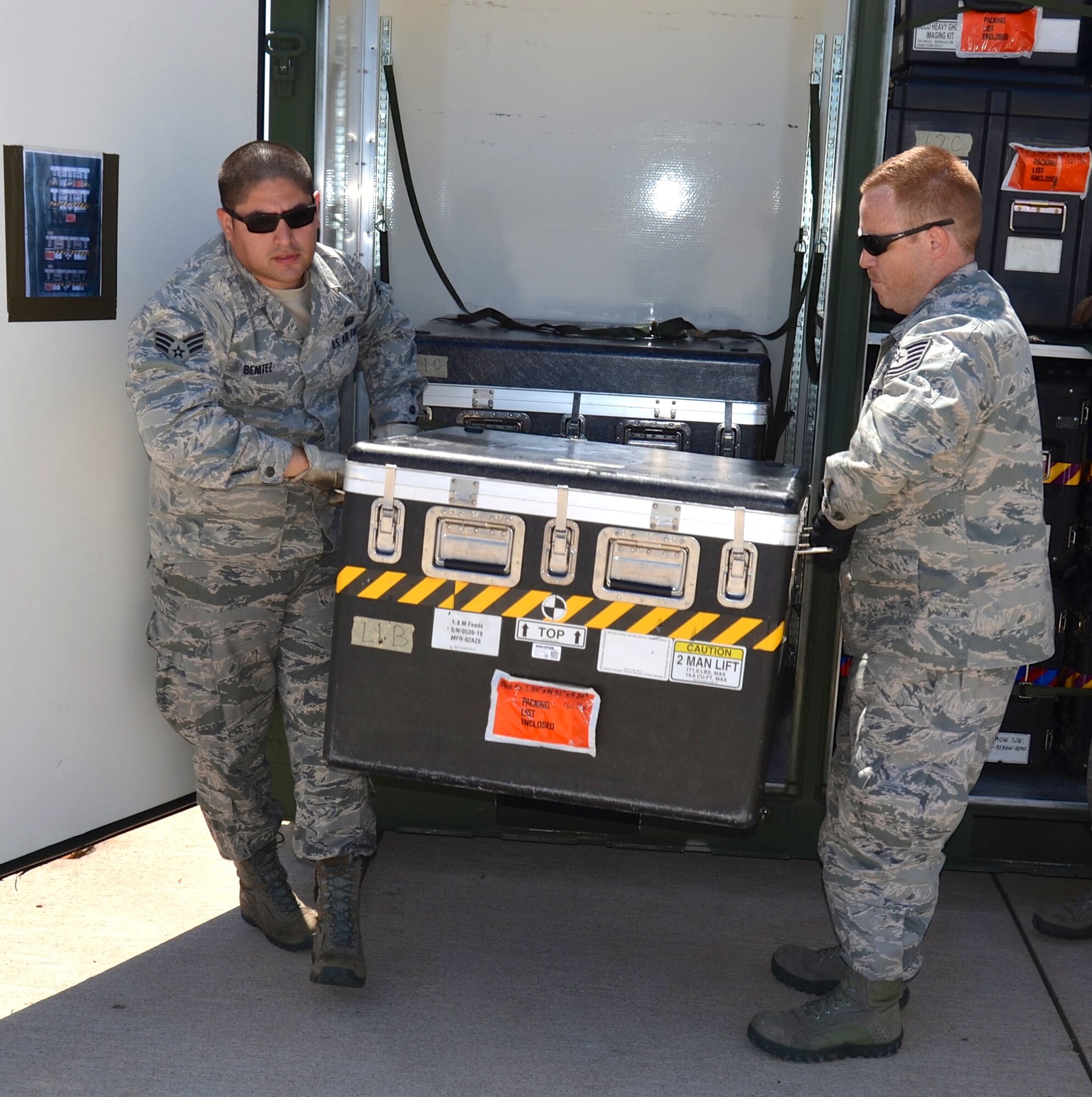 Senior Airman John Benitez, left, 433rd Airlift Control Flight, Joint Base San Antonio-Lackland, Texas and Tech Sgt. Zachery Rose, 315th Airlift Control Flight, Joint Base Charleston, South Carolina, unload communications equipment in preparation of air field set up during Air Force Reserve Command’s Patriot Hook 2015 exercise at Naval Auxiliary Landing Field on San Clemente Island, California April 15, 2015. The Patriot Hook Exercise, conducted by the Air Force Reserve Command, integrates federal agencies with the military, for world-wide mobility and readiness. (U.S. Air Force photo/Capt. Cris Medina)