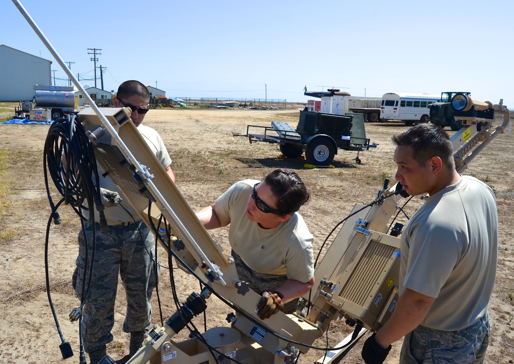 Airmen from the 433rd Airlift Control Flight, Joint Base San Antonio-Lackland, Texas set-up a satellite communications antenna at Naval Auxiliary Landing Field on San Clemente Island, California on April 15, 2015 during the Air Force Reserve Command’s Patriot Hook Exercise. The Patriot Hook Exercise, conducted by the Air Force Reserve Command, integrates federal agencies with the military, for world-wide mobility and readiness. (U.S. Air Force photo/Capt. Cris Medina)