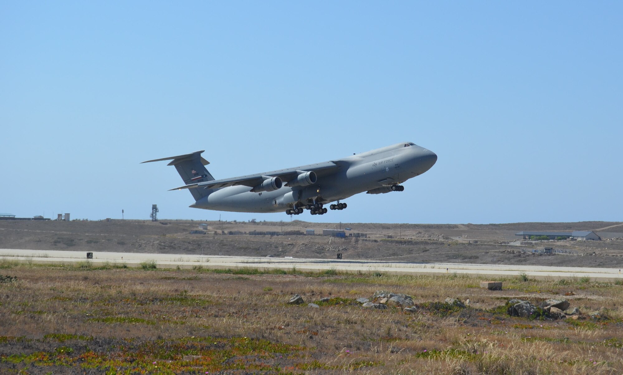 A C-5A Galaxy from the 433rd Airlift Wing, Joint Base San Antonio-Lackland, Texas departs Naval Auxiliary Landing Field on San Clemente Island, California during the Air Force Reserve Command’s 2015 Patriot Hook exercise on April 15, 2015.  (U.S. Air Force photo/Major Tim Wade)