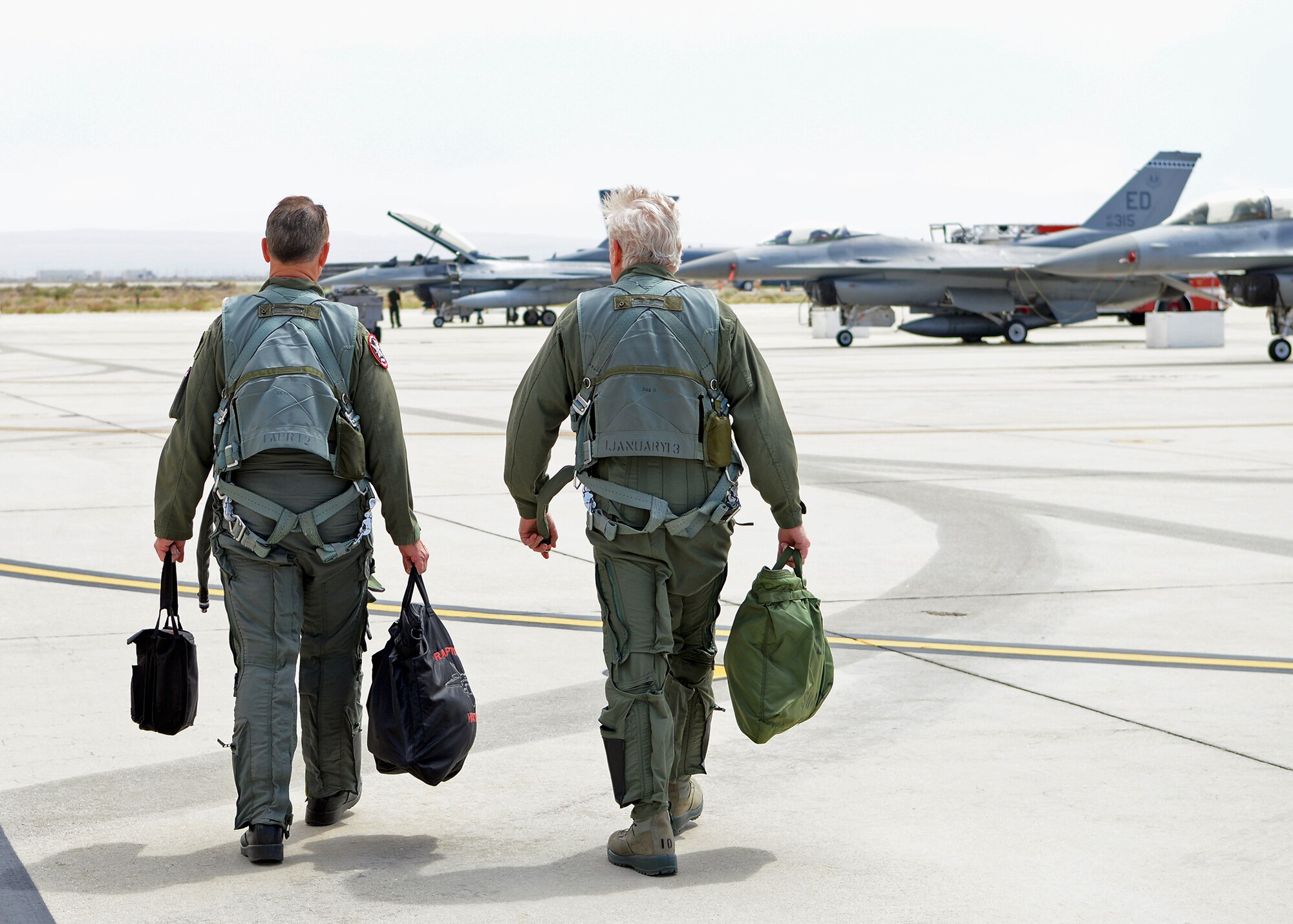 Steve Rainey (left), Lockheed Martin F-22 chief test pilot, and William Freckleton, 412 Range Squadron lead F-22 range control officer, walk out to an F-16 for Freckleton’s incentive flight that occurred April 21. Freckleton is the only decorated Vietnam veteran at the 411th Flight Test Squadron with 117 combat missions, one MiG-17 kill, 1,100 flight hours in the F-4 and 1,300 hours in the F-14, and 357 aircraft carrier landings who is retiring this year after more than 40 years of combined military and government civilian service. (U.S. Air Force photo by Jet Fabara)