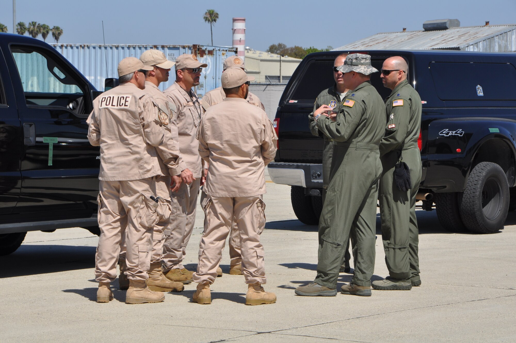Federal law enforcement officers from the Department of Homeland Security’s HSI Division, Los Angeles, confer with senior officers from the 452nd Airlift Control Flight, March Air Reserve Base, California, before boarding a C-17 Globemaster III, April 17, 2015 at Joint Forces Training Center at Los Alamitos, California. DHS was one of the several affiliates who participated in the annual Patriot Hook Exercise sponsored by the Air Force Reserve Command, which integrates federal agencies with the military. (U.S. Air Force photo/Capt. Cris Medina)