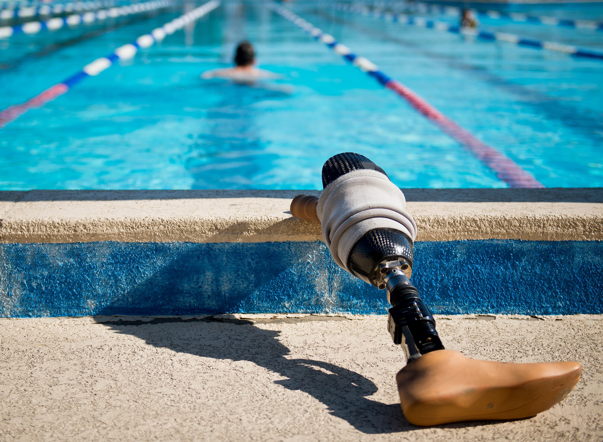 Master Sgt. Chris Ramakka, an active-duty Air Force Wounded Warrior athlete, leaves his prosthetic leg behind as he swims laps during the final day of the Warrior Games training camp at Eglin Air Force Base, Fla., April 22. The five-day training camp for the Air Force’s athletes serves as their last practice session before the Warrior Games June 19-28. (U.S. Air Force photo/Samuel King Jr.)