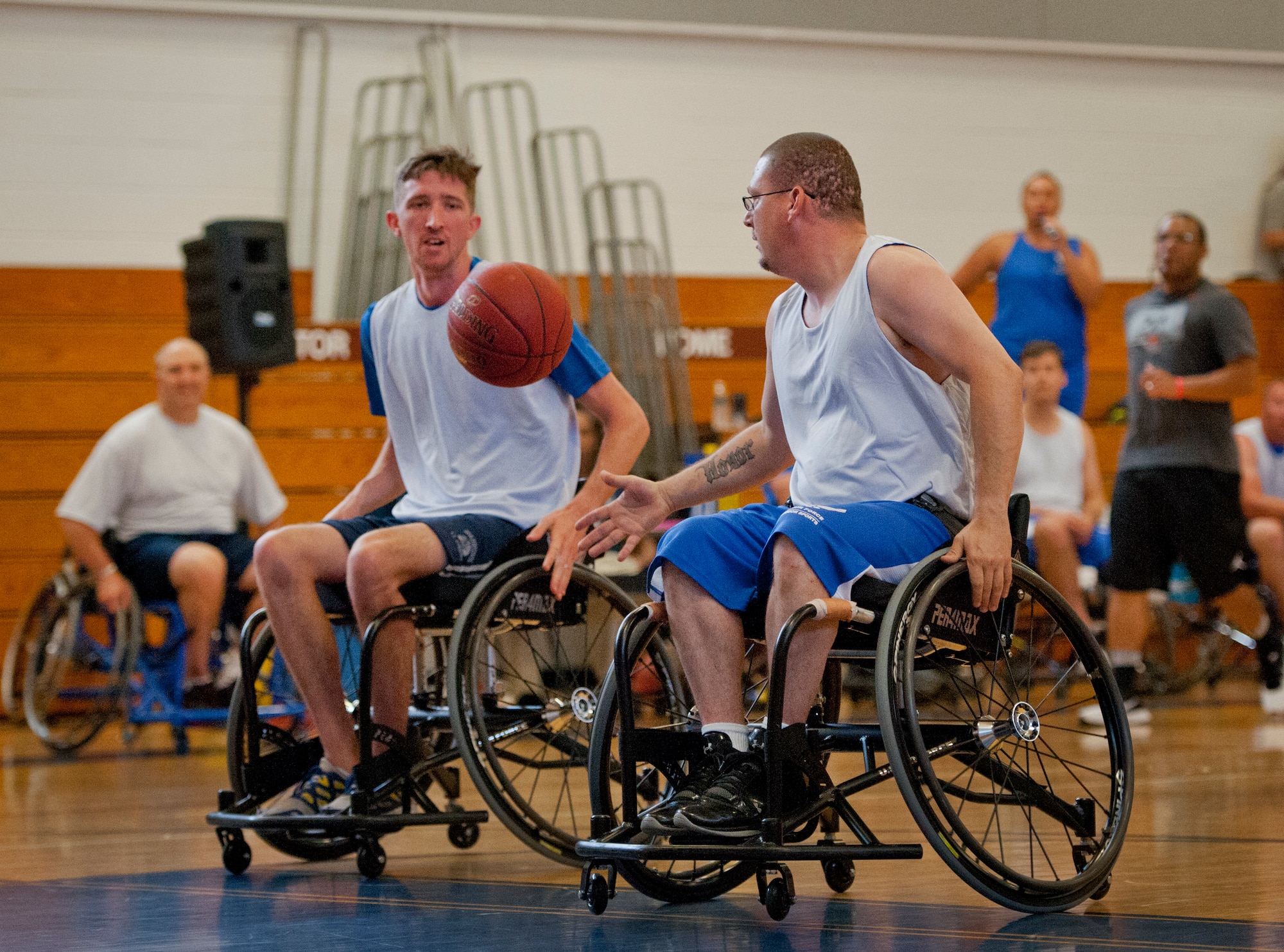 Air Force Wounded Warrior athletes, Tech. Sgt. Ryan Delaney passes the ball to Zachary Burnash at a wheelchair basketball game with base leadership during the final day of the Warrior Games training camp at Eglin Air Force Base, Fla., April 22. The five-day training camp for the Air Force’s athletes serves as their last practice session before the Warrior Games June 19-28. (U.S. Air Force photo/Samuel King Jr.)