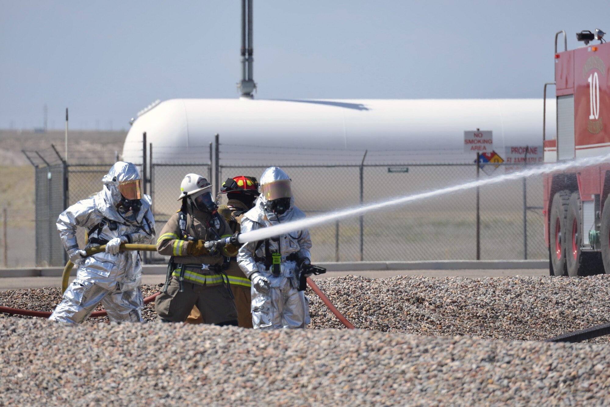 The Kirtland Air Force Base Fire Department joined with civilian departments on April 15 to practice battling a fire in and around a crashed aircraft. (Photo by Jamie Burnett)