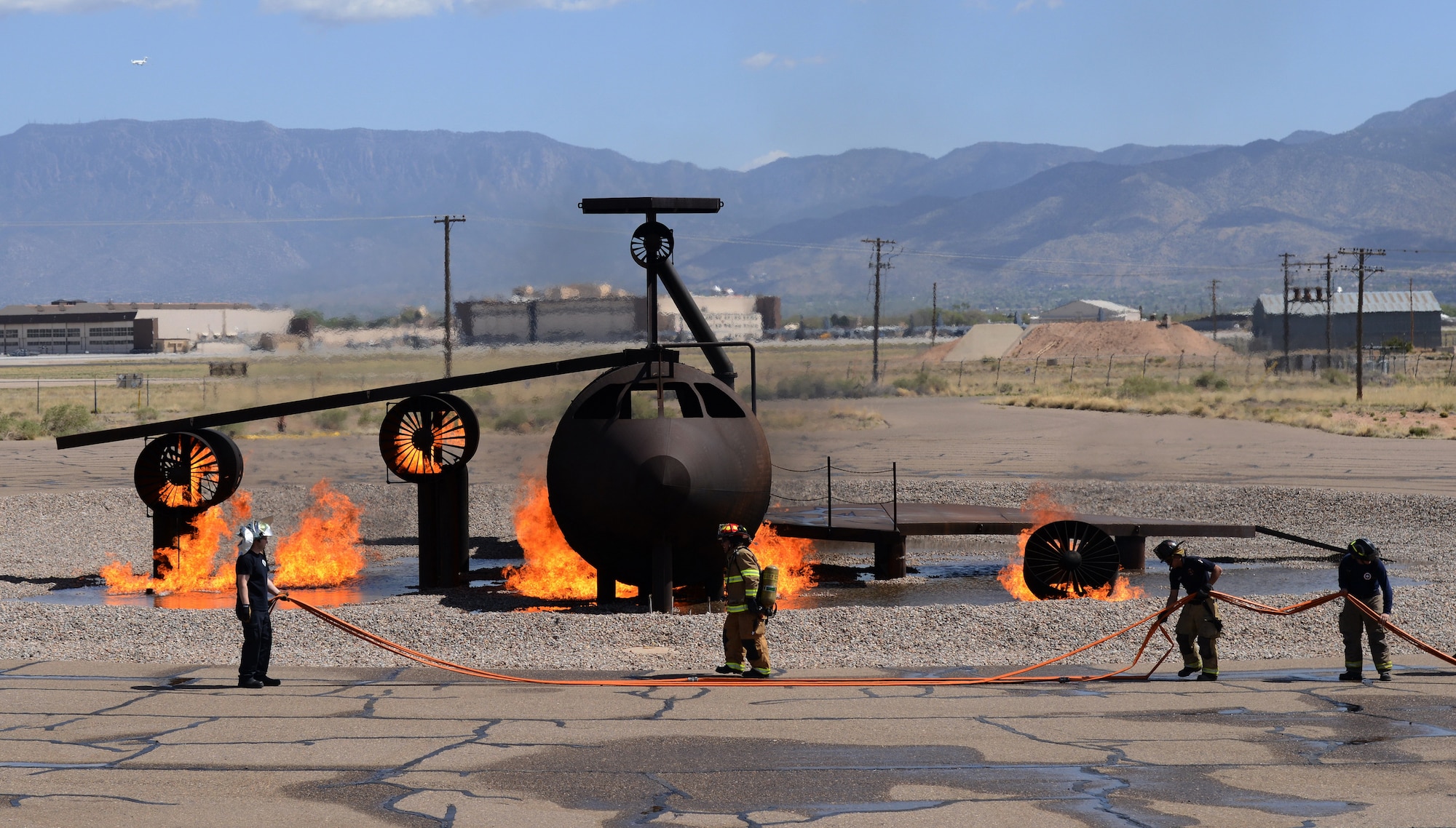 The Kirtland Air Force Base Fire Department joined with civilian departments on April 15 to practice battling a fire in and around a crashed aircraft. (Photo by Jamie Burnett)