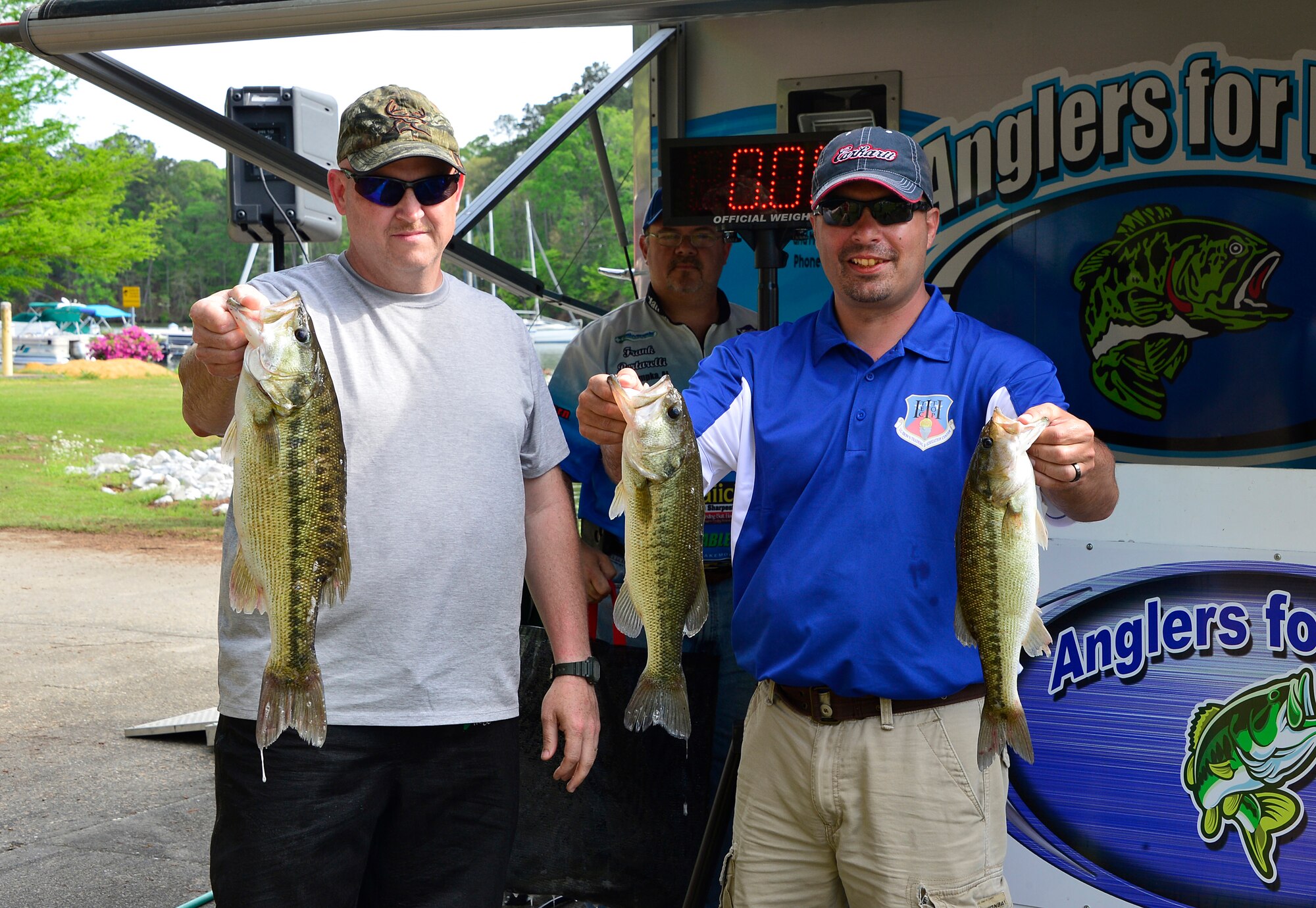 ALEXANDER CITY, Ala. - Chief Master Sgt. Herb Ward, left, and Master Sgt. Brian Shaner hold up three of the fish they reeled in during day one of the 20th annual Air National Guard bass tournament at Lake Martin, Ala. Ward is from the 110th Airlift Wing, and Shaner is from the I.G. Brown Training and Education Center. (U.S. Air National Guard photo by Master Sgt. Jerry Harlan/Released)