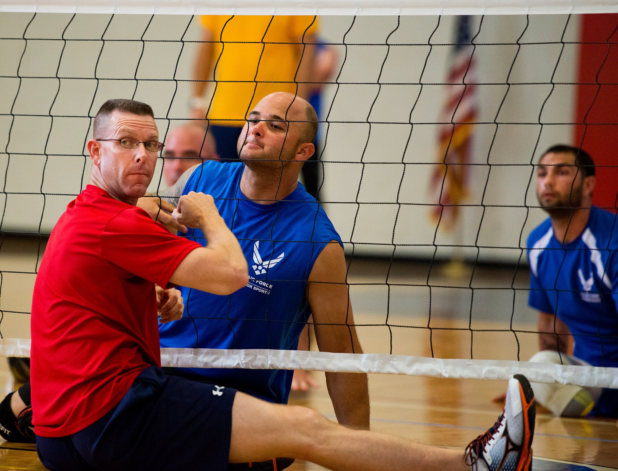 Chief Master Sgt. Brian Creager, 96th Test Wing command chief, and E.J. Newbern, an active-duty Air Force Wounded Warrior athlete, wait for the serve at a sitting volleyball game with base leadership during the final day of the Warrior Games training camp at Eglin Air Force Base, Fla., April 22. The five-day training camp for the Air Force’s athletes serves as their last practice session before the Warrior Games June 19-28. (U.S. Air Force photo/Samuel King Jr.)