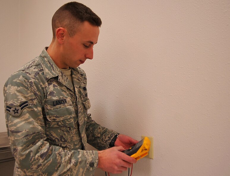Airman 1st Class Jacob Lanzer, 319th Civil Engineer Squadron electrical systems apprentice, tests the voltage on an outlet using a multimeter on Grand Forks Air Force Base, N.D., April 23, 2015. Lanzer was selected as the base’s Warrior of the Week for the fourth week in April. (U.S. Air Force photo by Airman 1st Class Bonnie Grantham/Released)