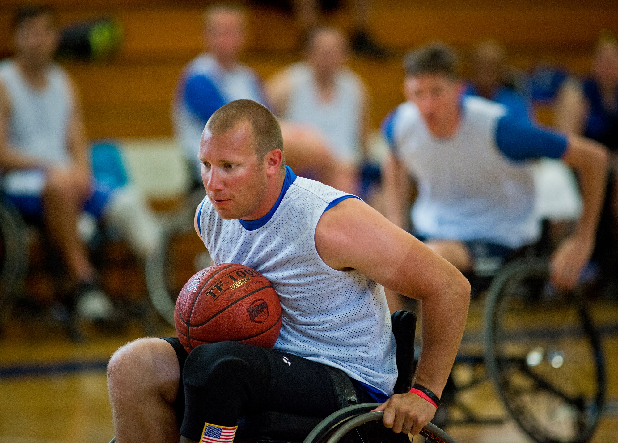 Jesse Graham, an active-duty Air Force Wounded Warrior athlete, rolls toward the goal during a fast break at a wheelchair basketball game with base leadership during the final day of the Warrior Games training camp at Eglin Air Force Base, Fla., April 22. The five-day training camp for the Air Force’s athletes serves as their last practice session before the Warrior Games June 19-28. (U.S. Air Force photo/Samuel King Jr.)
