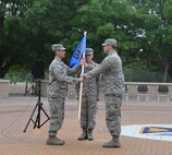 Col. Eric Shafa, left, 47th Mission Support Group commander, passes the 47th Logistics Readiness Flight guidon to Capt. Keith Carson as he assumes command of the LRF on Laughlin Air Force Base, Texas, April 22, 2015.  The assumption of command ceremony is part of a rich tradition that allows units to witness the formal transfer of command from one officer to another. (U.S. Air Force photo by 2nd Lt. Aaron Redfield)