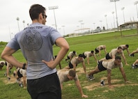 A Tactical Air Control Party (TACP) instructor from the 342nd Training Squadron at Joint Base San Antonio-Lackland, instructs students during group calisthenics. The Airmen will be a part of the first class to attend the TACP level-three apprentice course at JBSA-Lackland. The apprentice course was relocated from Hulburt Field Air Force Base, Florida. (U.S. Air Force photo by Airman First Class Justine Rho/released)