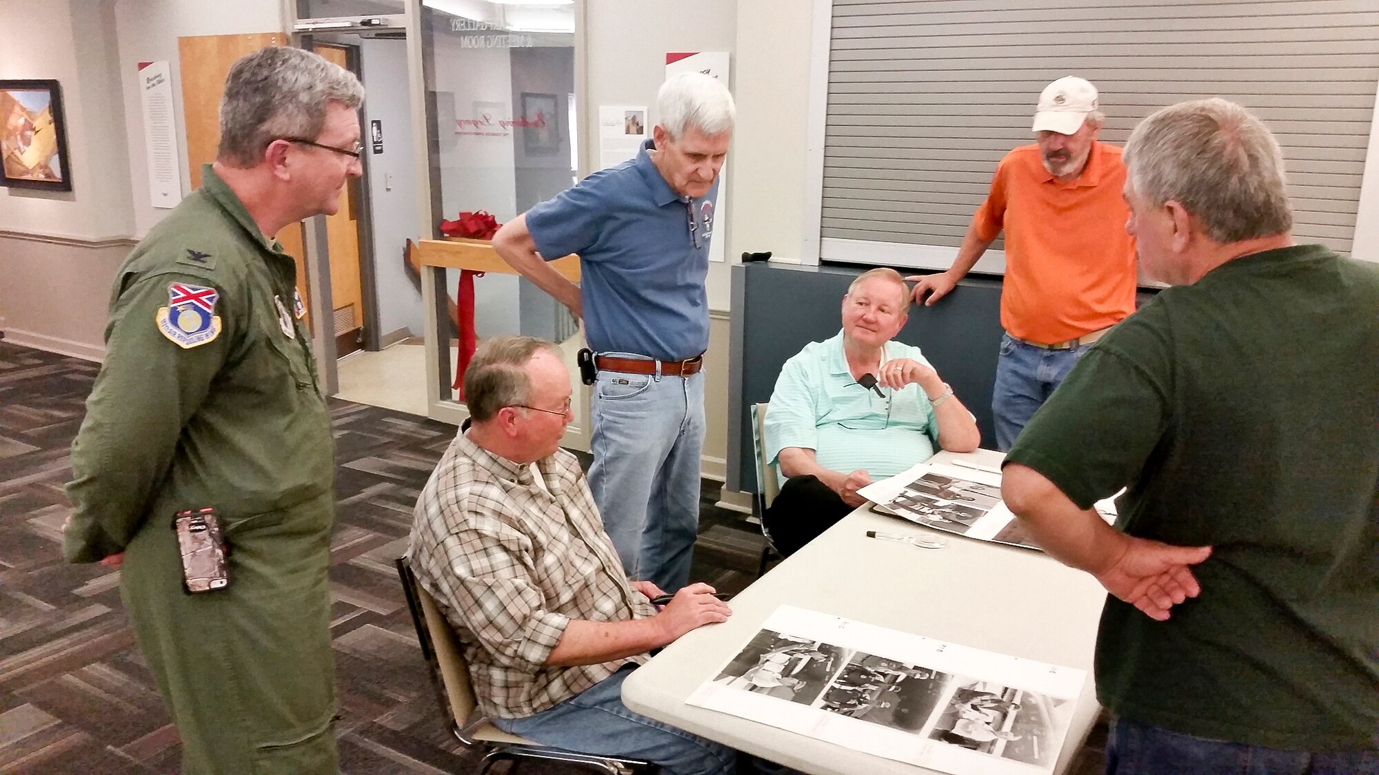 Past and present members of the 117th Air Refueling Wing copy and log historical unit photographs during a weekly meeting at the Southern Museum of Flight, Birmingham, Alabama. (U.S. Air National Guard photo by: Senior Master Sgt. Ken Johnson/Released)