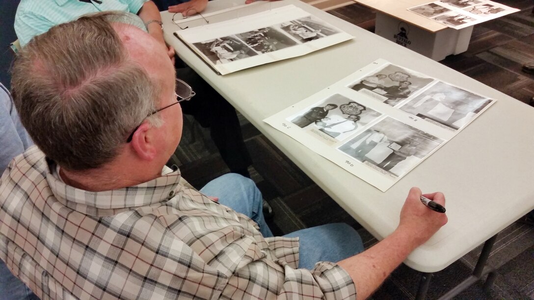 Past and present members of the 117th Air Refueling Wing copy and log historical unit photographs during a weekly meeting at the Southern Museum of Flight, Birmingham, Alabama. (U.S. Air National Guard photo by: Senior Master Sgt. Ken Johnson/Released)