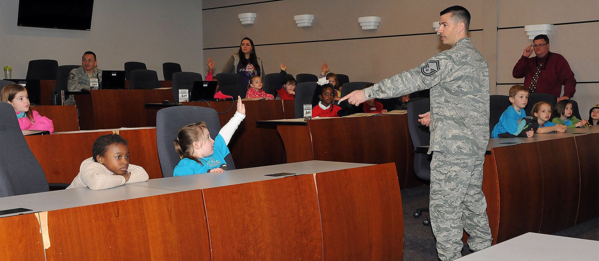 SMSgt Stephen Cochling call on students during a question and answer session. "The New Jersey Discovery School toured the U.S. Air Force Expeditionary Center and visited with Airmen on Joint Base McGuire-Dix-Lakehurst, NJ on 17 April 2015."
