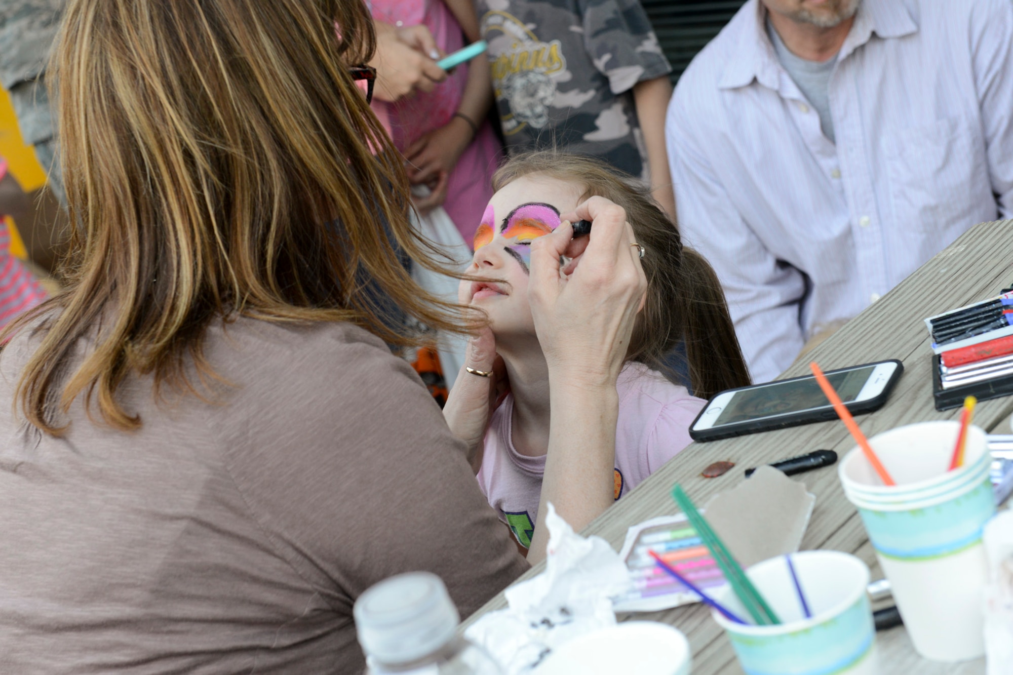 Tricia, daughter of Sarah and Staff Sgt. Chris Thorsbakken, gets her face painted at the 2015 Annual Easter Egg Hunt held outside of the Dining Facility of the 132d Wing, Des Moines, Iowa on Saturday, April 11, 2015.  (U.S. Air National Guard photo by Staff Sgt. Linda K. Burger/Released)