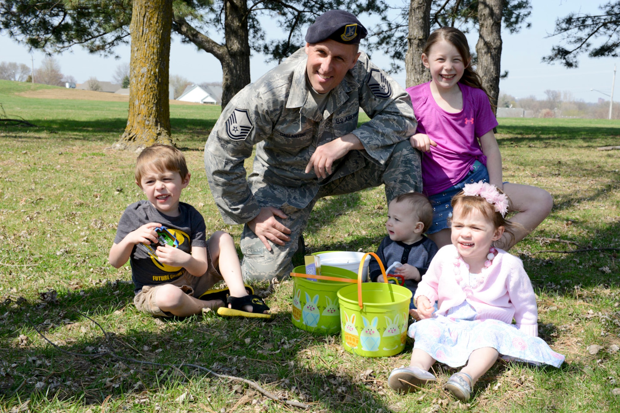 Master Sgt. Anthony Ballantini (middle, in uniform) poses for a photo with his children during the 2015 Annual Easter Egg Hunt held outside of the Dining Facility of the 132d Wing, Des Moines, Iowa on Saturday, April 11, 2015.  (U.S. Air National Guard photo by Staff Sgt. Linda K. Burger/Released)