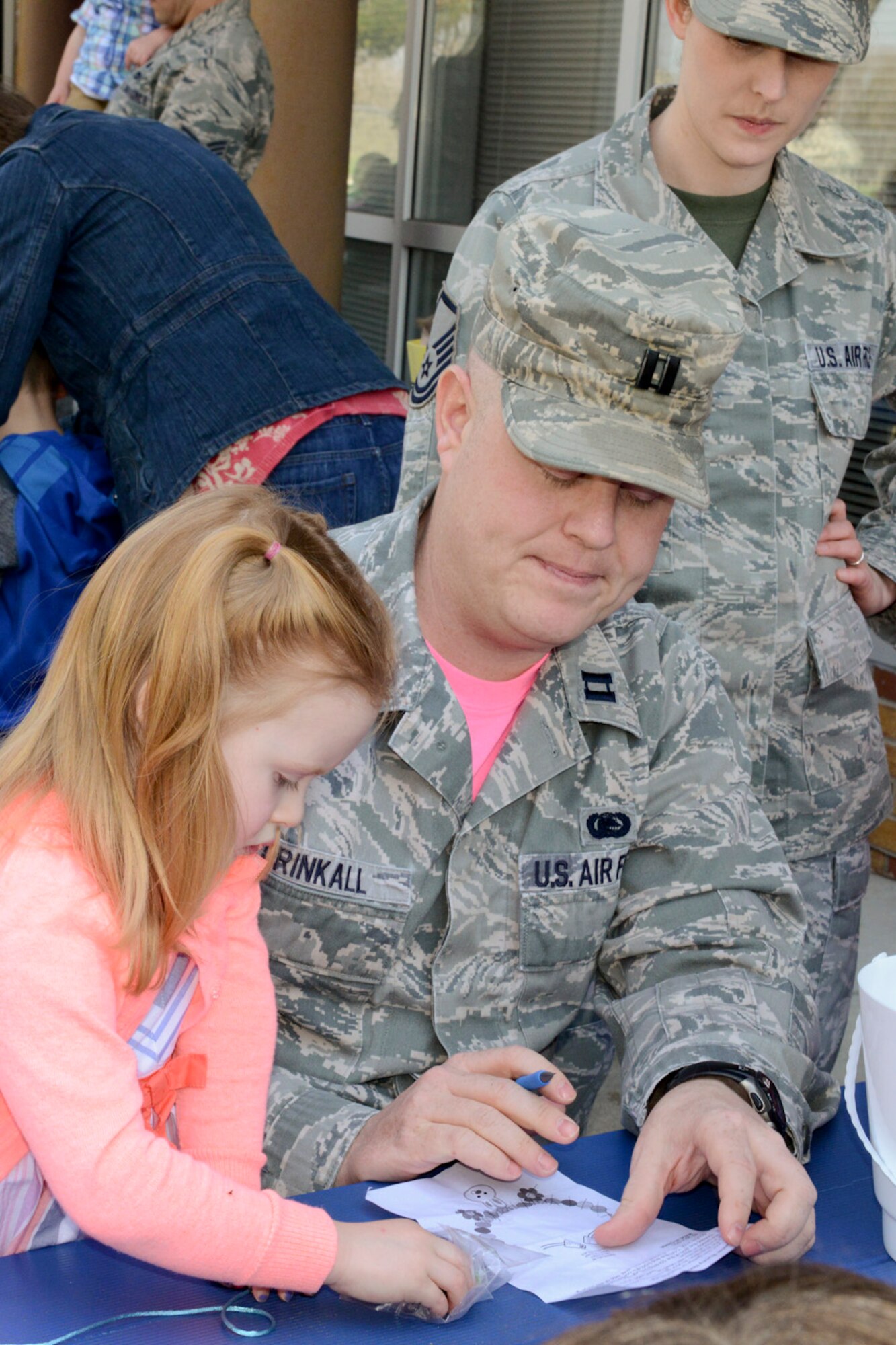 Capt. Lee Drinkall (middle) and Master Sgt. Charisse Drinkall make crafts with their daughter Scarlett during the 2015 Annual Easter Egg Hunt held outside of the Dining Facility of the 132d Wing, Des Moines, Iowa on Saturday, April 11, 2015.  (U.S. Air National Guard photo by Tech. Sgt. Michael B. McGhee/Released)