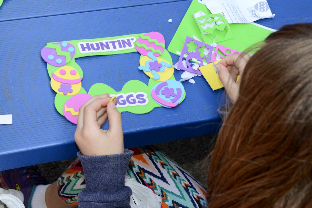 Mackenzie, daughter of Melissa and Tech Sgt. Michael McGhee, makes crafts during the 2015 Annual Easter Egg Hunt held outside of the Dining Facility of the 132d Wing, Des Moines, Iowa on Saturday, April 11, 2015.  (U.S. Air National Guard photo by Tech. Sgt. Michael B. McGhee/Released)