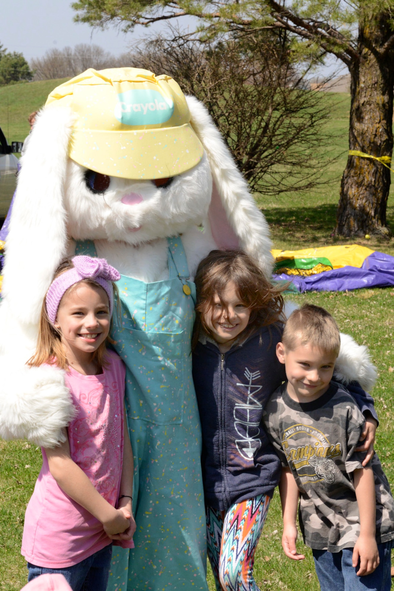 Madison (left), Mackenzie (middle) and Marik (right), children of Melissa and Tech Sgt. Michael McGhee, have their photo taken with the Easter Bunny during the 2015 Annual Easter Egg Hunt held outside of the Dining Facility of the 132d Wing, Des Moines, Iowa on Saturday, April 11, 2015.  (U.S. Air National Guard photo by Tech. Sgt. Michael B. McGhee/Released)