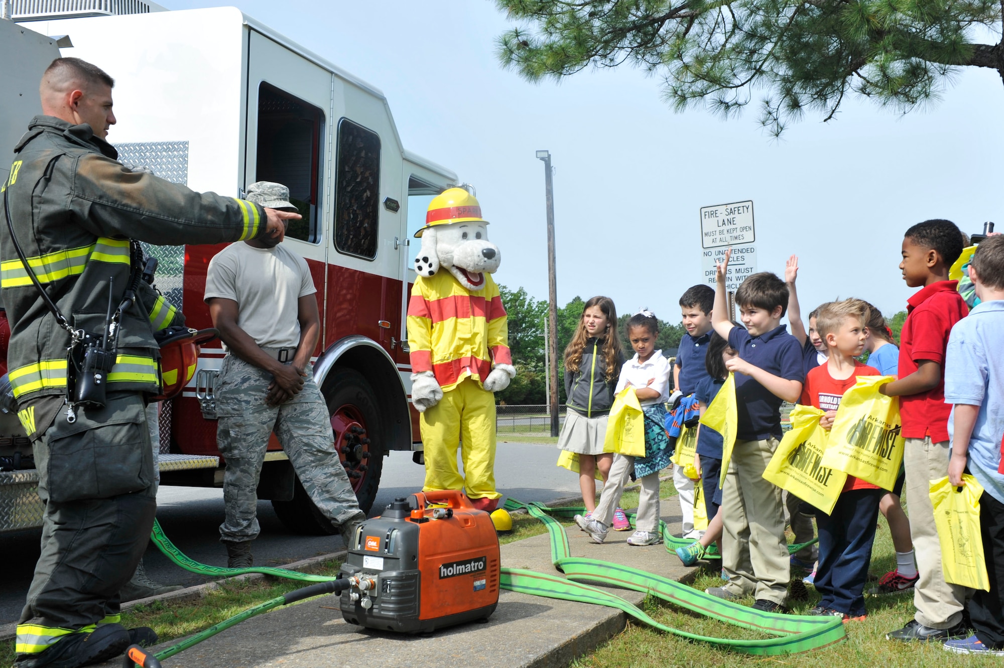 The 19th Civil Engineer Squadron fire department answers questions about fire safety and Earth Day April 22, 2015, at Little Rock Air Force Base, Ark. The event also featured visits by Sparky the Fire Dog, McGruff the Crime Dog. (U.S. Air Force photo by Senior Airman Regina Edwards)