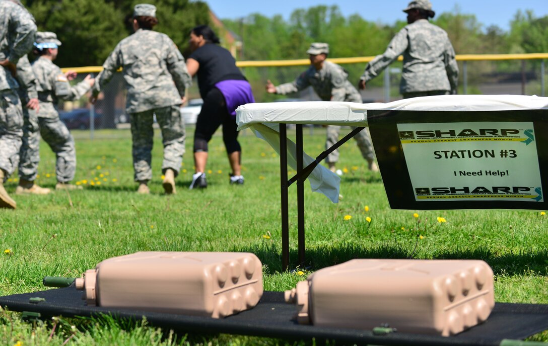 Members of the 93rd Signal Brigade help a teammate during the “Carry the Load” competition at Fort Eustis, Va., April 22, 2014. The 93rd SB won the competition which involved completing five stations that promote team work while carrying loaded ammunition cans on a gurney to each station. (Photo by U.S. Air Force Staff Sgt. Natasha Stannard/Released)