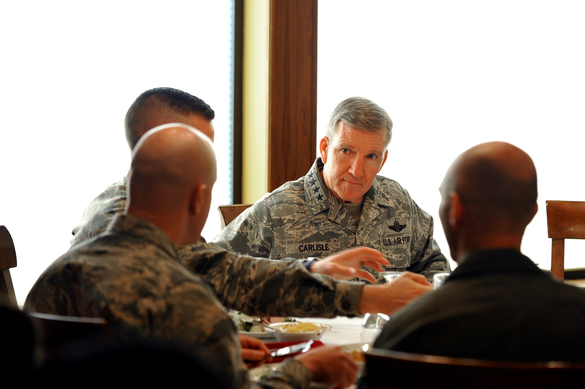 U.S. Air Force Gen. Hawk Carlisle, commander of Air Combat Command, meets with company grade officers for lunch during a trip to Offutt Air Force Base, Nebraska April 20-21, 2015. Carlisle visited Offutt to see the mission first hand and to discuss ACC priorities with Airmen.  (U.S. Air Force photo by Josh Plueger/Released)