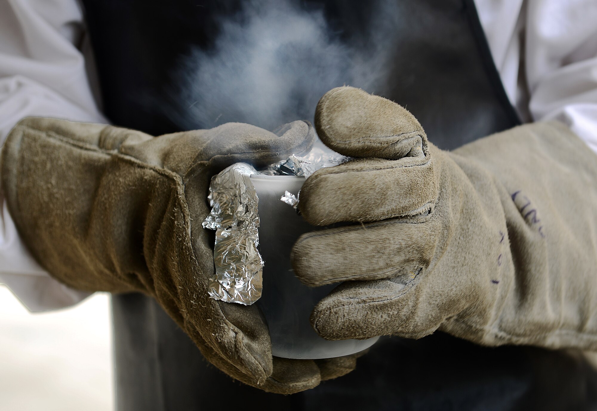 U.S. Air Force Senior Airman Nicholas McGinnis, 31st Logistics Readiness Squadron fixed facilities personnel, collects a sample of liquid oxygen, April 23, 2015, at Aviano Air Base, Italy. Every 90 days, petroleum, oil and lubricants Airmen inspect liquid oxygen tank locks for leaks and test the oxygen's purity. (U.S. Air Force photo by Senior Airman Matthew Lotz/Released)