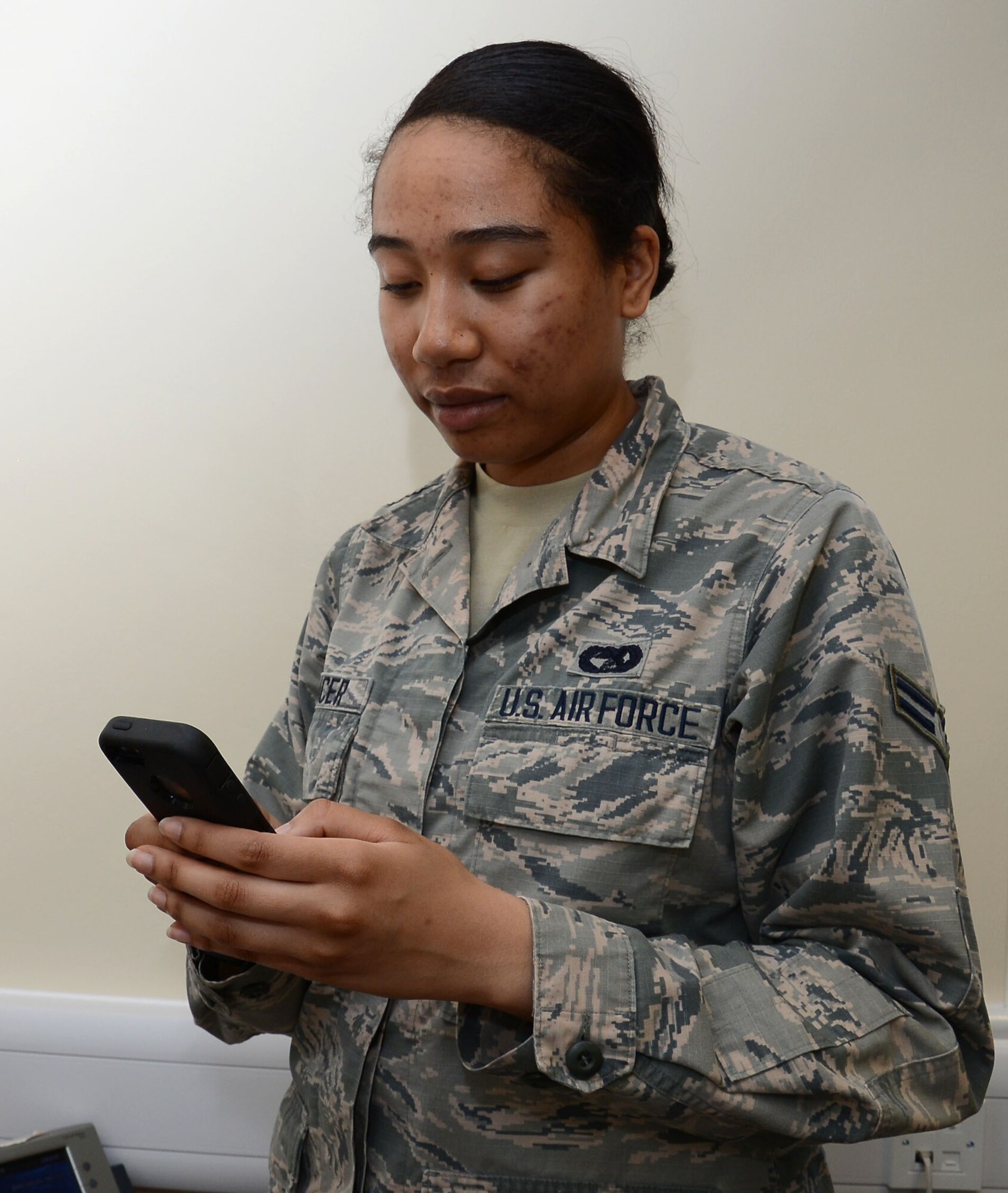 U.S. Air Force Airman 1st Class Tynisha Spencer, 100th Logistics Readiness Squadron traffic management journeyman from Fairfield, Calif., shows how easy it is to dial a number with the new DUI prevention application April 9, 2015, on RAF Mildenhall, England. The new DUI prevention application allows users to call Airmen Against Drunk Driving, a taxi or a supervisor with the simple touch of a button. (U.S. Air Force photo by Gina Randall/Released)