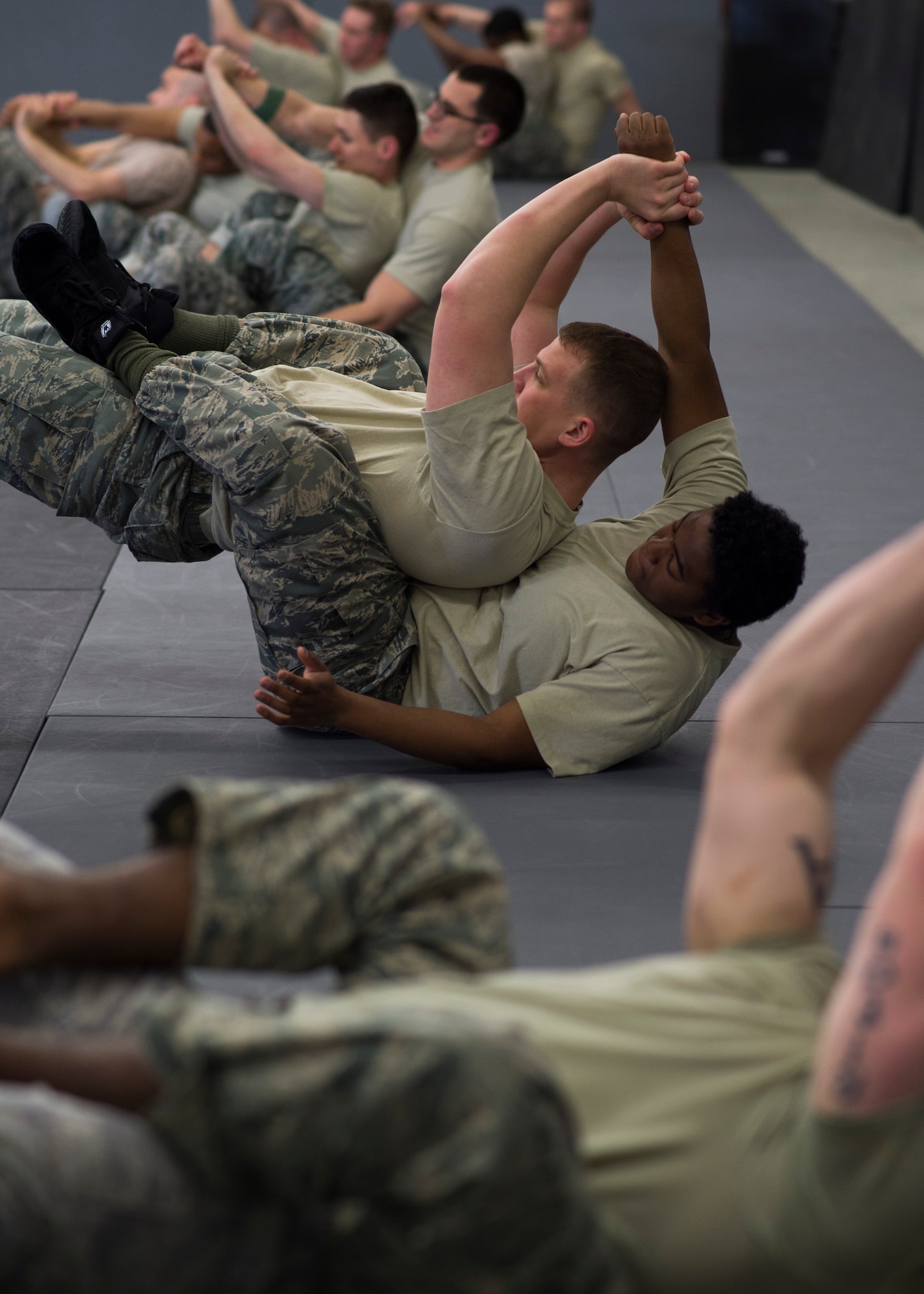 Staff Sgt. Bryan Thayer, left, and Senior Airman Terell White, 569th U.S. Forces Police Squadron installation patrolmen, practice combative moves during a Fly Away Security course Feb. 14, 2015, at Ramstein Air Base, Germany. The ten-day pre-deployment course teaches defenders how to protect airframes and aircrew and also focuses on communication, hand-to-hand combat and basic mission planning techniques. (U.S. Air Force photo/Senior Airman Damon Kasberg)