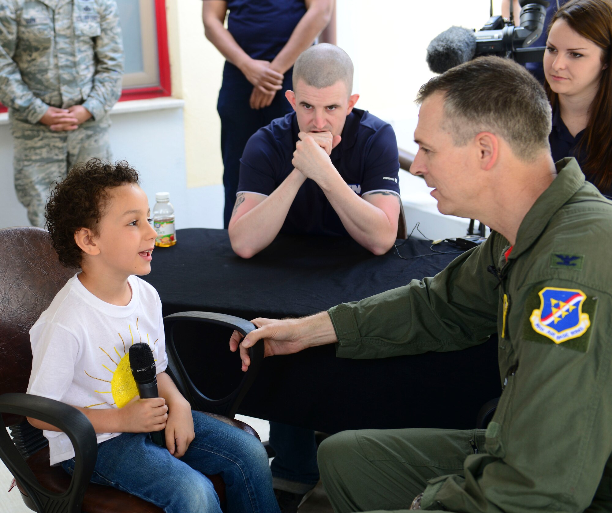 Dominic, a 39th Air Base Wing dependent, interviews Col. Craig Wills, 39th Air Base Wing commander, during a radio show at the Incirlik Child Development Center April 17, 2015 at Incirlik Air Base, Turkey. The interview followed a parade of military member’s children. (U.S. Air Force photo by Staff Sgt. Eboni Reams/Released) 