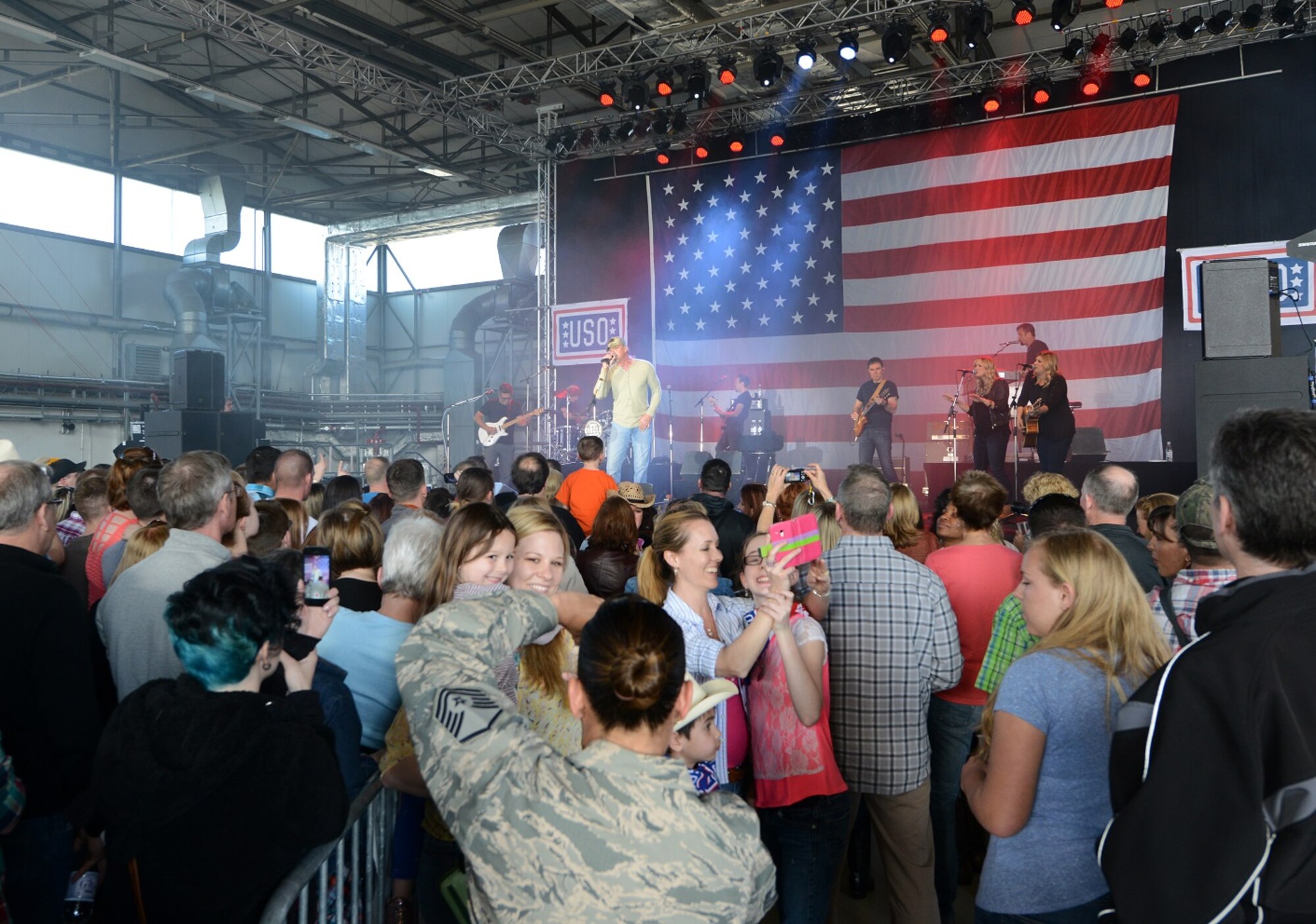 Trace Adkins, country music singer, performs for members of the Kaiserslautern Military Community April 20, 2015, at Ramstein Air Base, Germany. Adkins is celebrating the Grand Ole Opry’s 90th anniversary during a ten-day USO tour and is performing on a replica of the six-foot circle of wood that sits center stage at the Grand Ole Opry House. (U.S. Air Force photo/Airman 1st Class Tryphena Mayhugh)