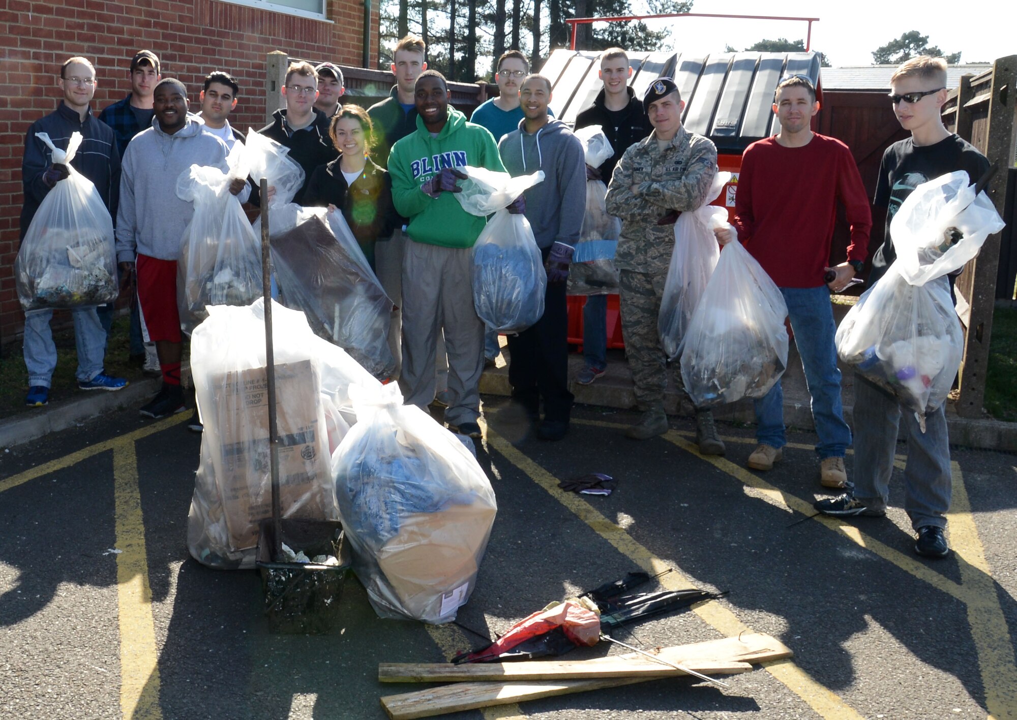 Members from the 100th Security Forces Squadron pose for a photograph following a cleanup  April 21, 2015, on RAF Mildenhall, England. The participates were mainly from the 100th SFS and the 100th Civil Engineer Squadron Fire Department but the walk was open to all Airmen and civilians on base as part of the earth week activities. (U.S. Air Force photo by Gina Randall/Released)