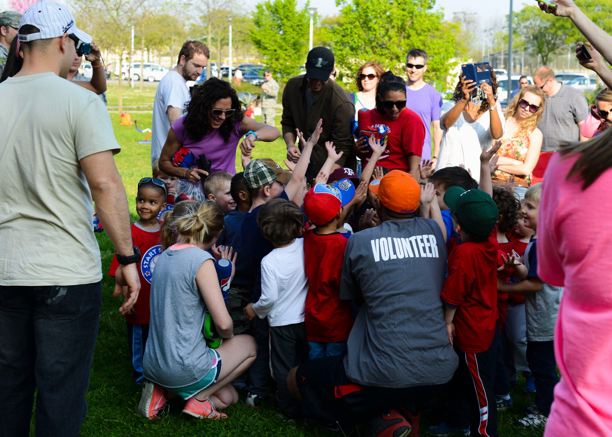 Children and their parents gather around after a Start Smart baseball practice before heading home April 21, 2015, at Aviano Air Base, Italy. Youth enrichment programs like these happen every day at installations across the globe, which showcase the appreciation and dedication the military community cultivated toward children. (U.S. Air Force photo by Senior Airman Austin Harvill/Released)