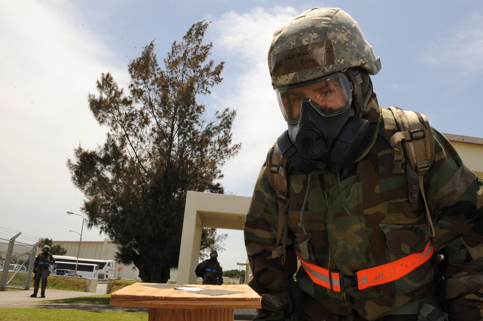 U.S. Air Force Staff Sgt. Estrella Martinez, 18th Wing Public Affairs broadcaster, checks a strip of chemically reactive paper for evidence of harmful substances following a simulated chemical attack on Kadena Air Base, Japan, April 23, 2015. The paper used during post-attack reconnaissance sweeps changes colors when exposed to different chemicals. By observing the colors on the paper, or lack thereof, trained personnel are able to determine what chemicals are present in the environment. (U.S. Air Force photo by Airman 1st Class Zade C. Vadnais)