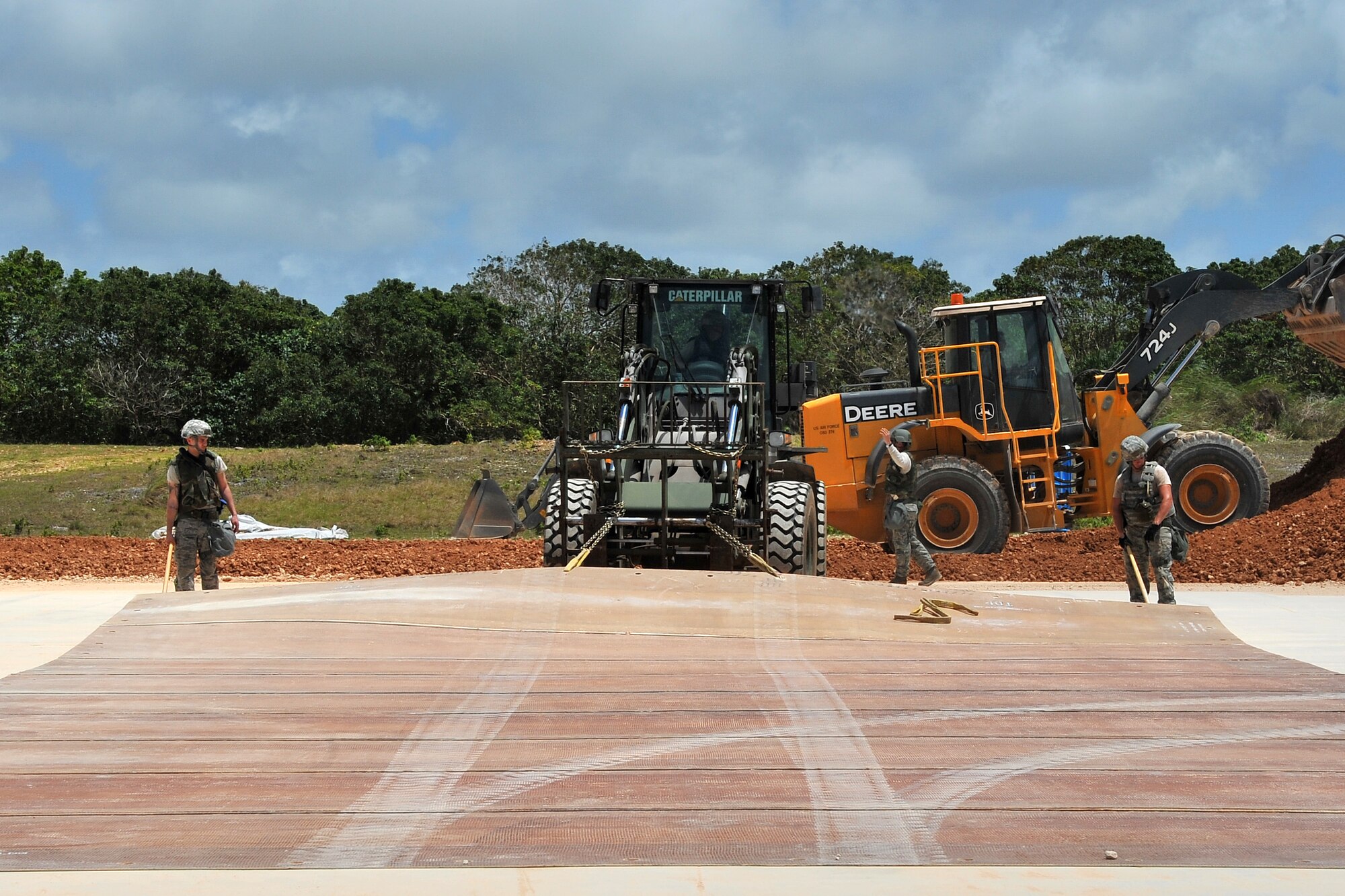 Pacific Air Forces civil engineer Airmen install a folding fiberglass mat over a filled crater to cover foreign object damage during airfield damage repair training at the Pacific Air Forces’ Silver Flag site on Northwest Field, Guam, April 21, 2015. Airmen throughout PACAF participate in Silver Flag to exercise various expeditionary skills including ADR, where engineers provide a rapid, semi-permanent repair during combat operations to allow airfield operations to resume quickly. (U.S. Air Force photo by Staff Sgt. Melissa B. White/Released))