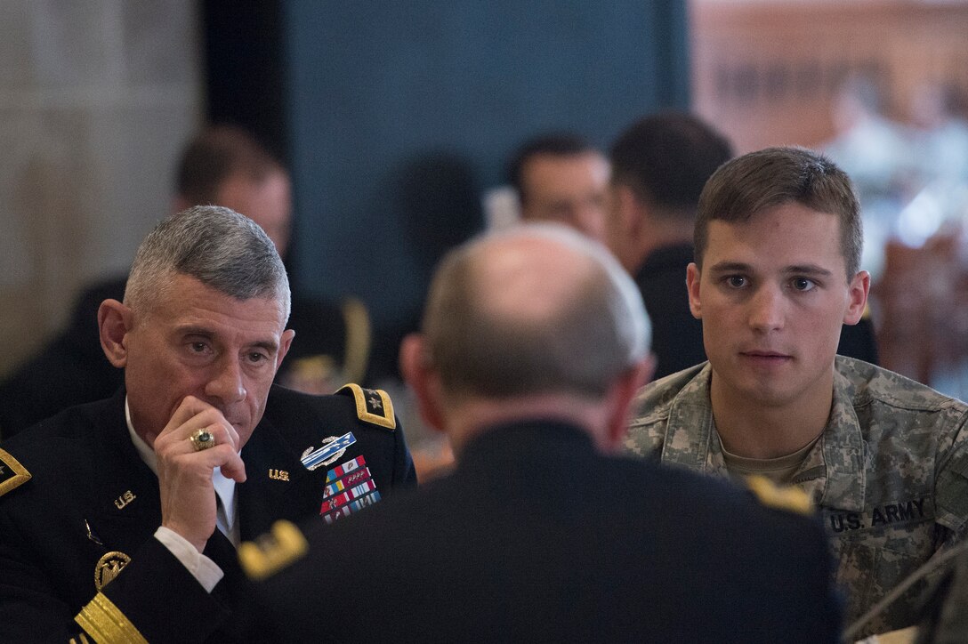 Superintendent of the U.S. Military Academy Army Lt. Gen. Robert L. Caslen Jr., left, and a cadet listen as Army Gen. Martin E. Dempsey, chairman of the Joint Chiefs of Staff, talks with cadets in the dining hall of the United States Military Academy at West Point, New York, April 22, 2014. Dempsey was on a two-day tour of the U.S. Naval Academy, U.S. Military Academy and Harvard University.
