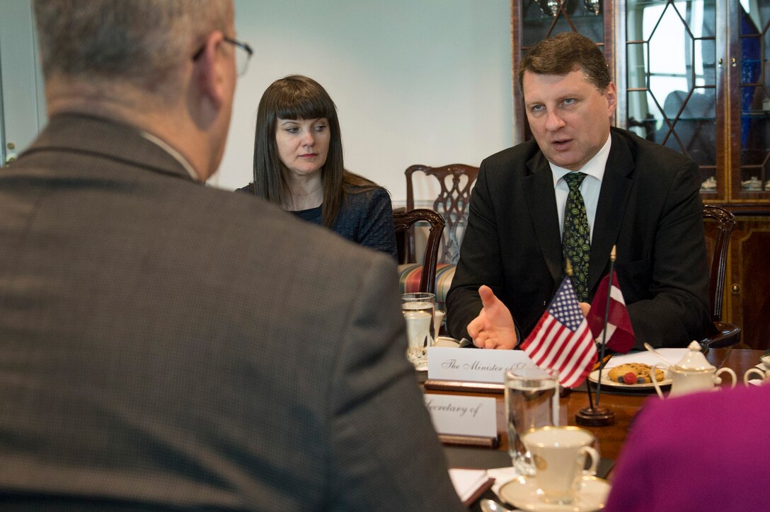 Latvian Defense Minister Raimonds Vejonis, right, talks during a meeting with U.S. Deputy Defense Secretary Bob Work, left foreground, as the two leaders discussed matters of mutual importance at the Pentagon, April 23, 2015.