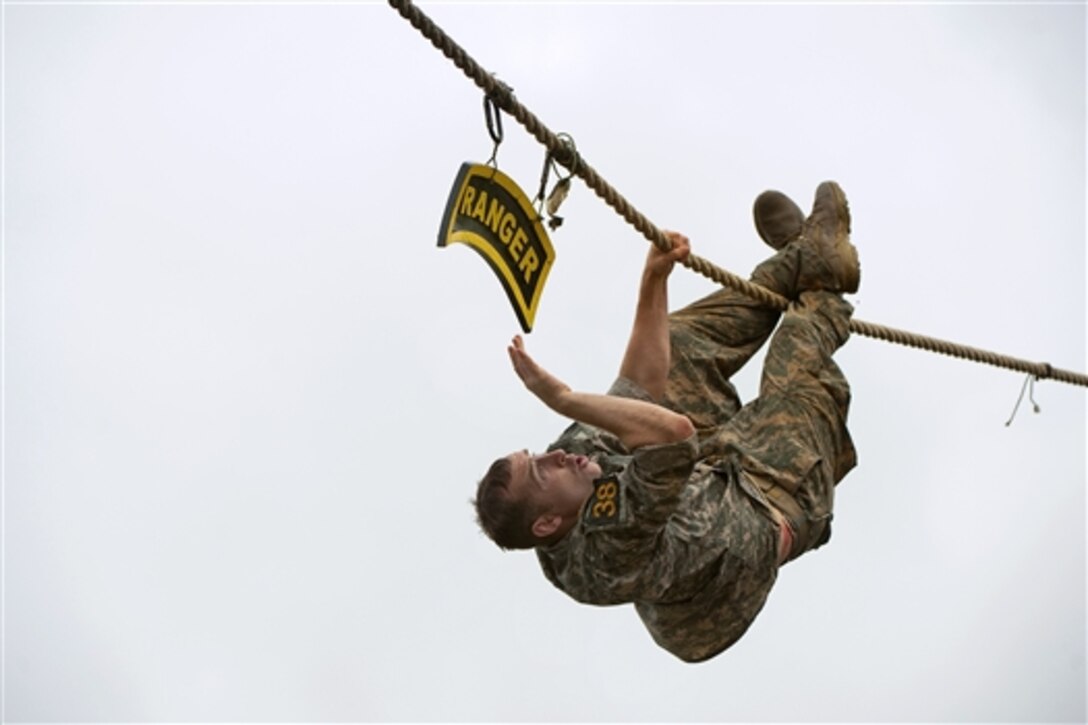 Army Sgt. 1St Class Jeremy Lemma prepares to touch the Ranger sign and drop into Victory Pond below to continue the assessment for combat water survival during the 2015 Best Ranger Competition on Fort Benning, Ga., April 12, 2015. Lemma is assigned to the Airborne and Ranger Training Brigade.