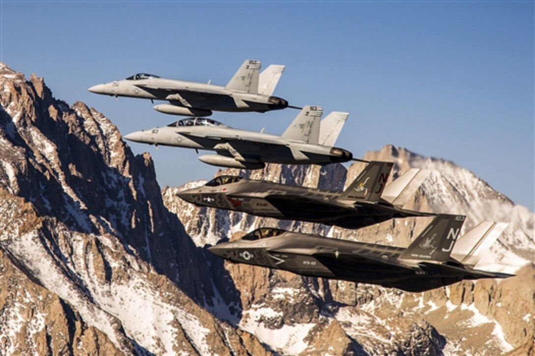 Two F-35C Lightning II aircraft fly in formation with two F/A-18E/F Super Hornets over the Sierra Nevada mountain range, April 14, 2015. The flight is part of a six-day visit by Strike Fighter Squadron 101 to Naval Air Station Lemoore, Cailf., the future site for the F-35C.