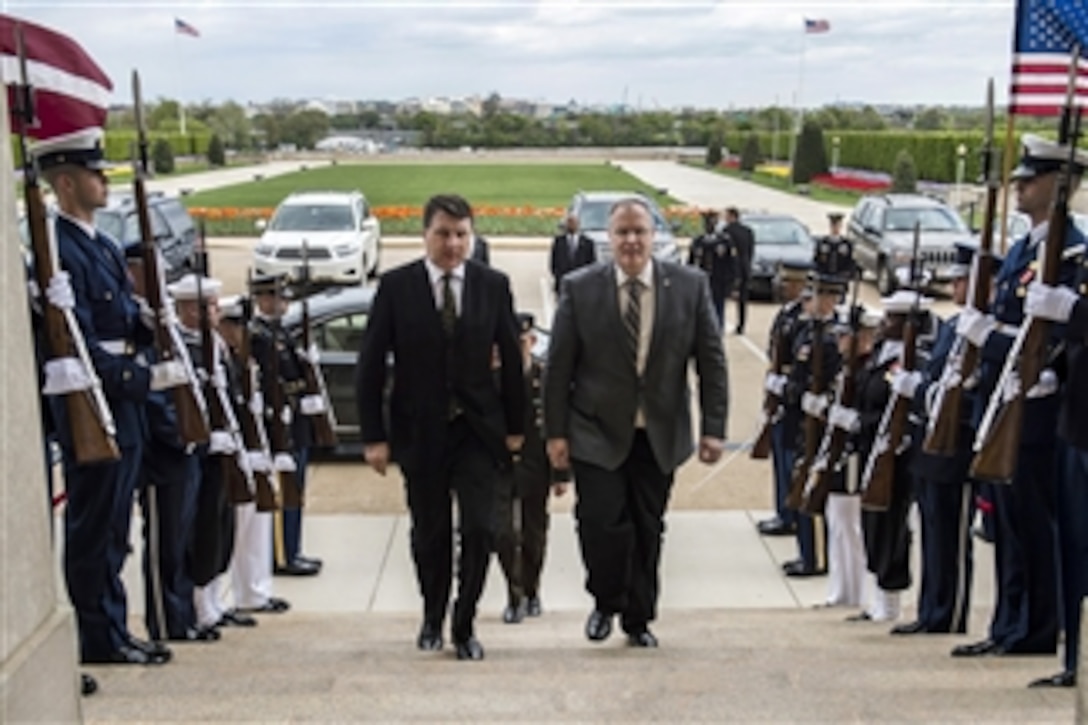 U.S. Deputy Defense Secretary Bob Work, right, hosts an honor cordon for Latvian Defense Minister Raimonds Vejonis at the Pentagon, April 23, 2015. The two defense leaders met to discuss matters of mutual importance. 