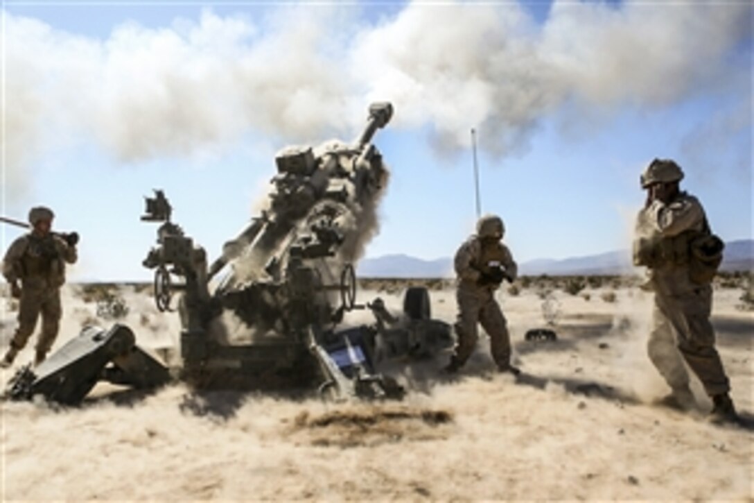 Marines prepare for the impact from an M777A2 155-mm howitzer during Desert Scimitar 2015 on Marine Corps Air Ground Combat Center in Twentynine Palms, Calif., April 20, 2015. The Marines are assigned to the 1st Marine Division's 1st Battalion, 11th Marine Regiment.