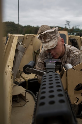Cpl. Matthew Mitchell, a Motor Transport mechanic with Marine Wing Support Squadron 171, Motor-T Company, aims down the sight of a M240 bravo machine gun at the Japan Ground Self-Defense Force’s Haramura Maneuver Area in Hiroshima, Japan, April 13, 2015, as part of Exercise Haramura 1-15. Haramura is a weeklong company-level training event focused on reinforcing the skills Marines learned during Marine Combat Training as well as during their Military Occupational Specialty schooling.