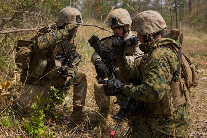 Combat engineer team leaders with Marine Wing Support Squadron 171, Engineer Company, combat engineer platoon, discus their plan of attack before assaulting an enemy position during a foot patrol and breaching drill on the Japan Ground Self-Defense Force’s Haramura Maneuver Area in Hiroshima, Japan, as part of Exercise Haramura 1-15 April 15, 2015. Haramura is a weeklong company-level training exercise was focused on reinforcing the skills Marines learned during Marine Combat Training and their Military Occupational Specialty schooling.