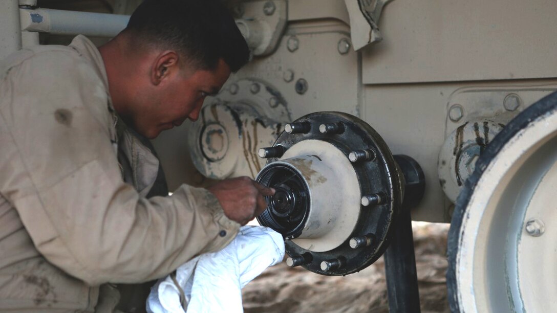 Corporal Christian Bills, gunner, Company A, 1st Tank Battalion, 1st Marine Division, nicknamed “America’s Company,” performs maintenance on his M1A1 Abrams Main Battle Tank named Star Lord during Exercise Desert Scimitar aboard Marine Corps Air Ground Combat Center Twentynine Palms, California, April 11, 2015. Desert Scimitar enables 1st Marine Division to test and refine its command and control capabilities and ensures 1st Marine Division units remain committed to consistently improving the quality of their training efforts and their resultant warfighting capabilities.